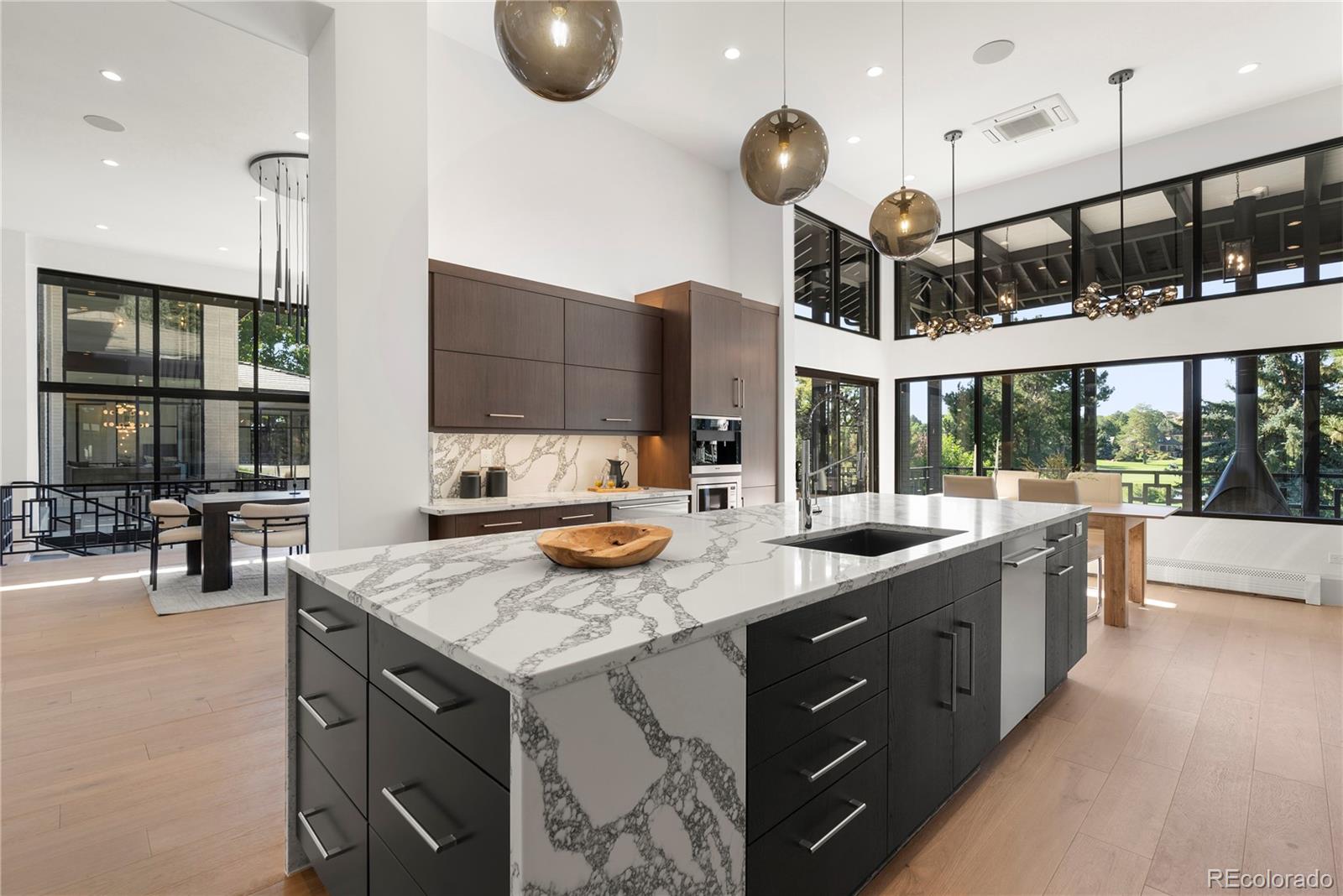 3962 South Chase Way Denver, CO 80235 - Photo 20 of 40 a kitchen with a sink a counter space appliances and cabinets