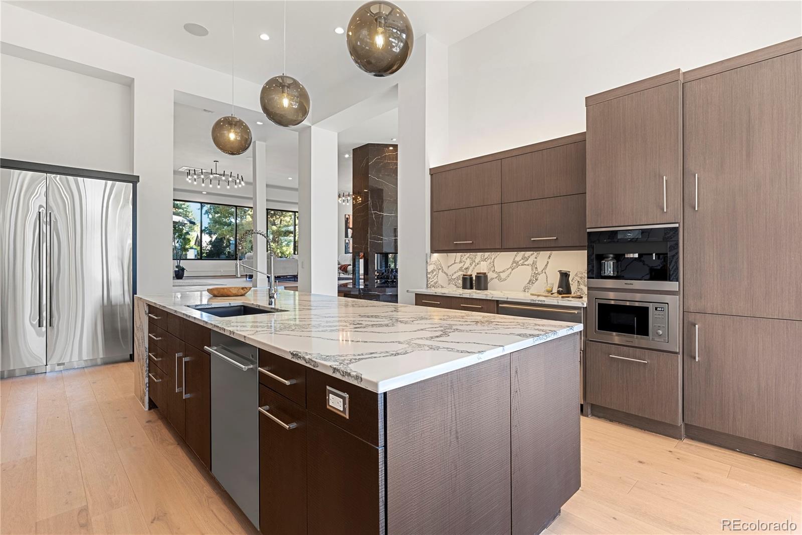 3962 South Chase Way Denver, CO 80235 - Photo 21 of 40 a kitchen with stainless steel appliances granite countertop a stove a sink and a refrigerator