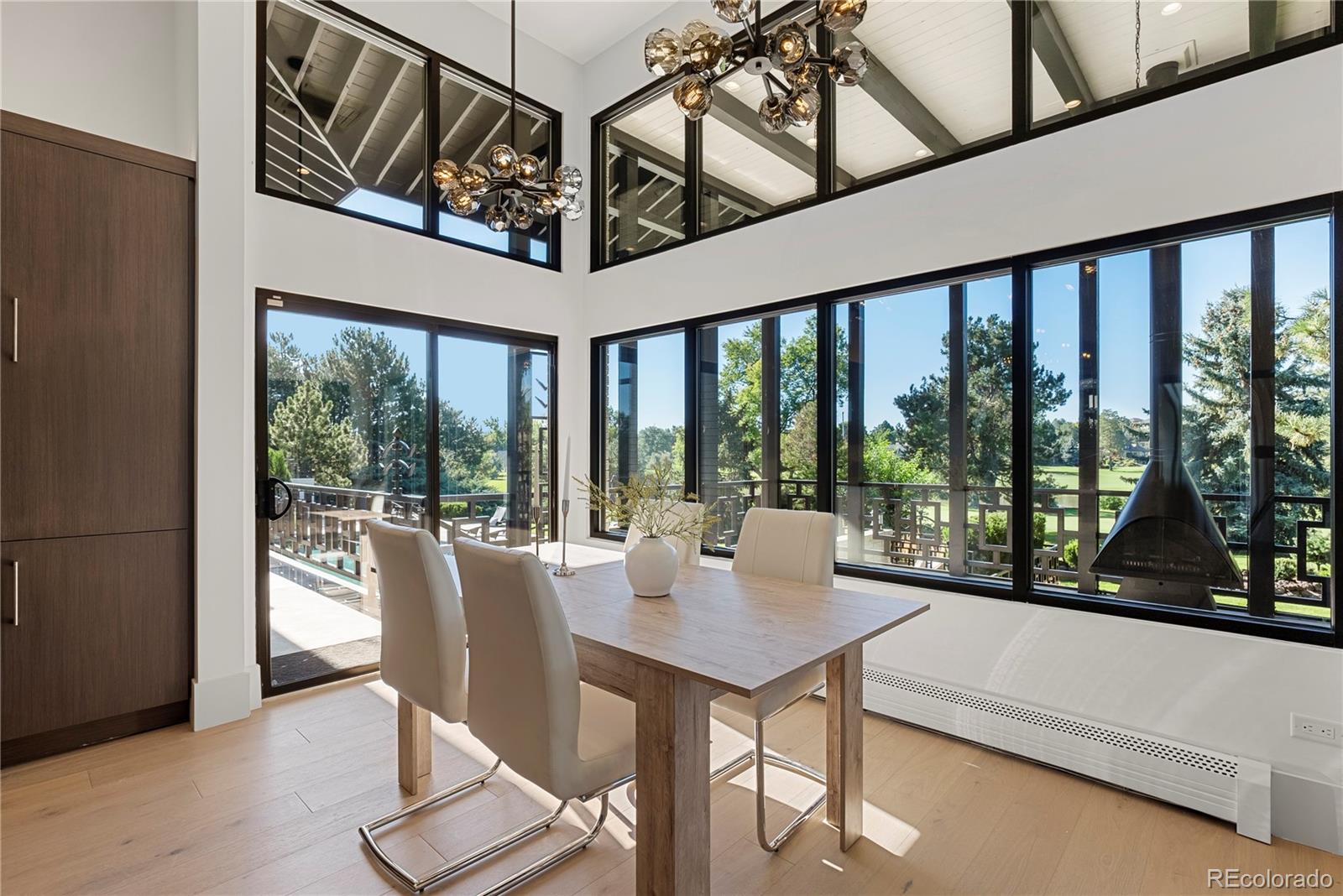 3962 South Chase Way Denver, CO 80235 - Photo 22 of 40 a view of a living room and floor to ceiling window furniture