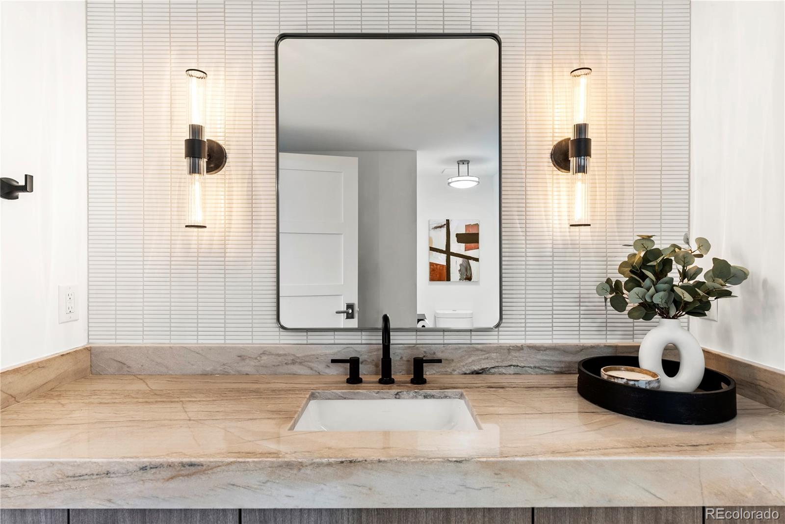 3962 South Chase Way Denver, CO 80235 - Photo 23 of 40 a bathroom with a sink and a mirror