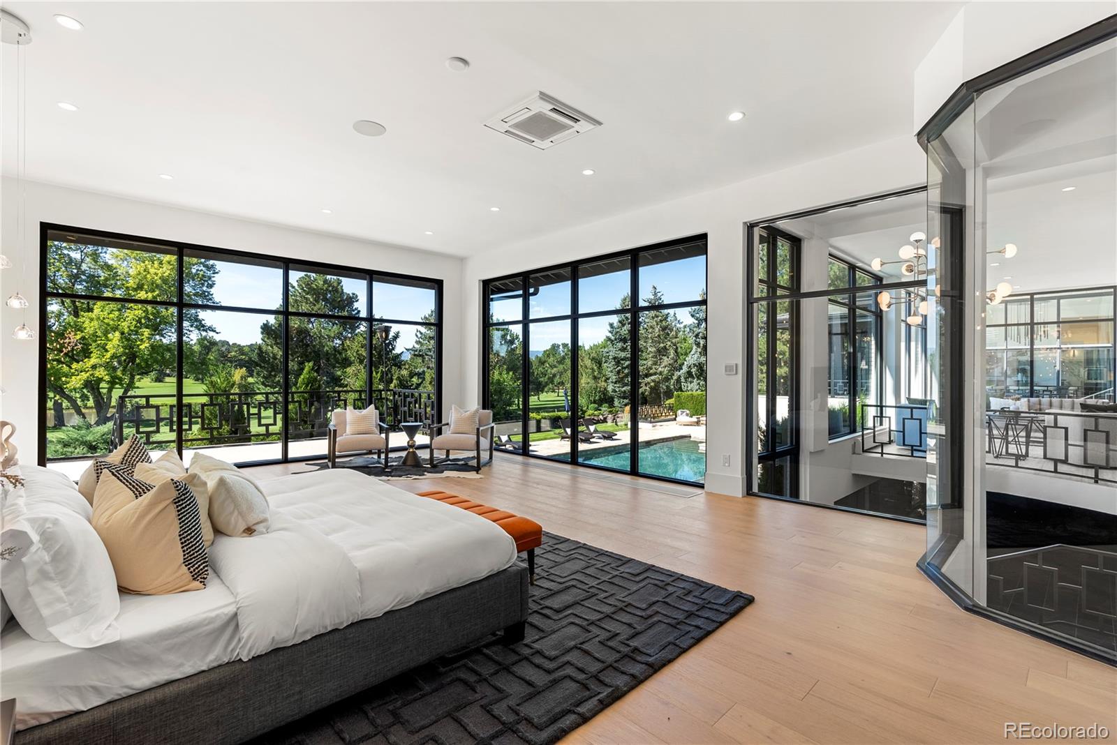 3962 South Chase Way Denver, CO 80235 - Photo 24 of 40 a large bedroom with a large bed and a large window