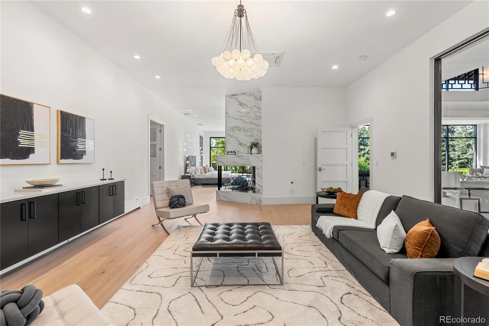 3962 South Chase Way Denver, CO 80235 - Photo 27 of 40 a living room with furniture and a chandelier
