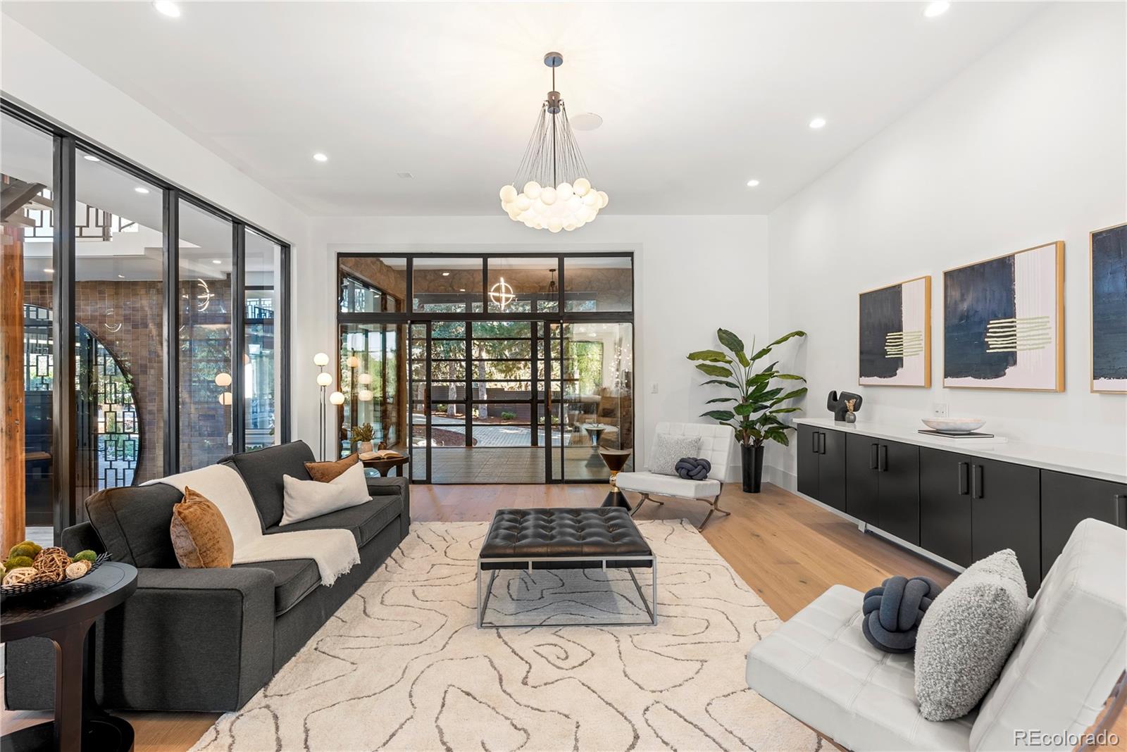 3962 South Chase Way Denver, CO 80235 - Photo 28 of 40 a living room with furniture fireplace and large windows