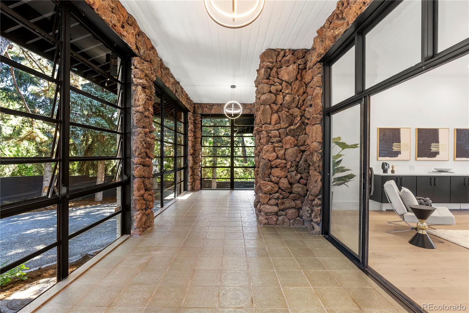 3962 South Chase Way Denver, CO 80235 - Photo 29 of 40 a view of entryway and hall with dining area
