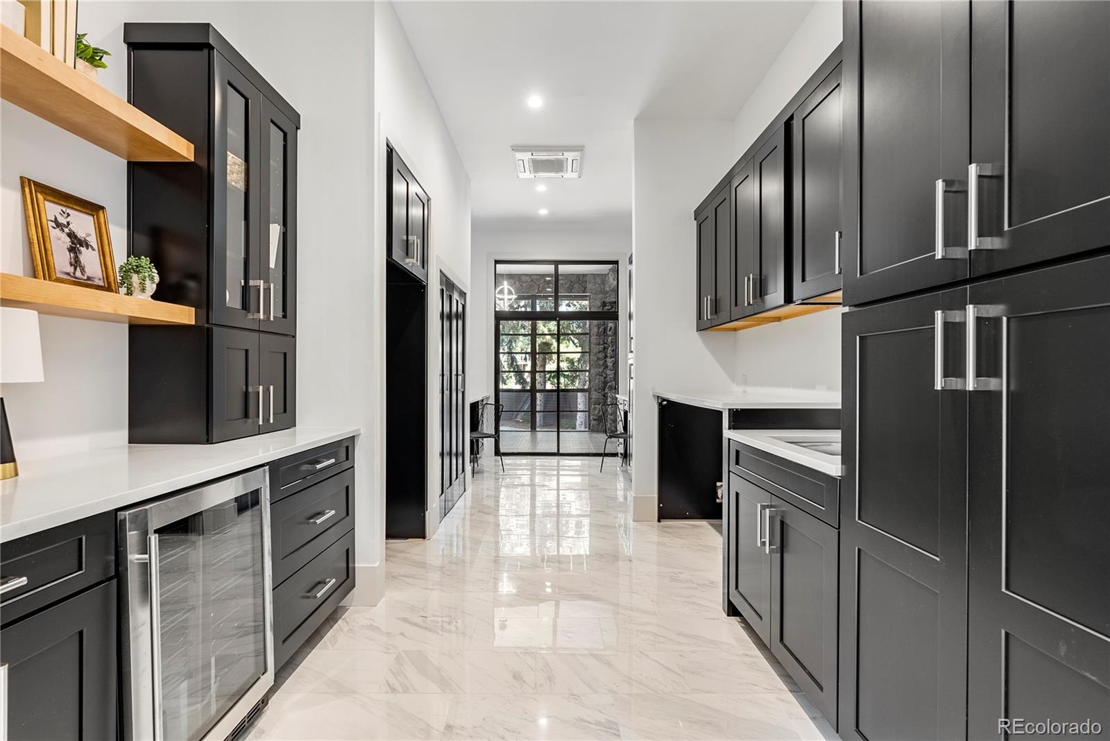 3962 South Chase Way Denver, CO 80235 - Photo 30 of 40 a kitchen with stainless steel appliances granite countertop a refrigerator and a stove