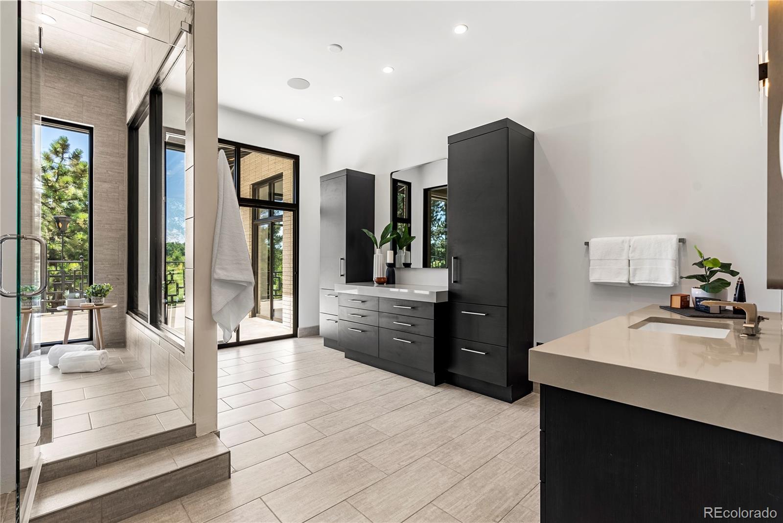 3962 South Chase Way Denver, CO 80235 - Photo 31 of 40 a kitchen with stainless steel appliances kitchen island granite countertop a refrigerator and a sink