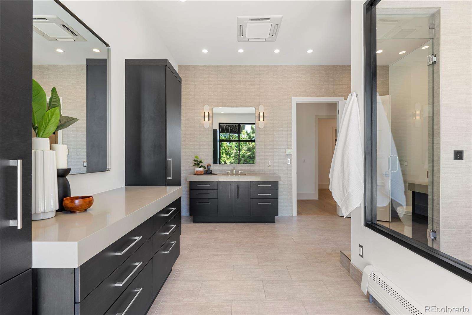3962 South Chase Way Denver, CO 80235 - Photo 32 of 40 a bathroom with a tub sink and mirror