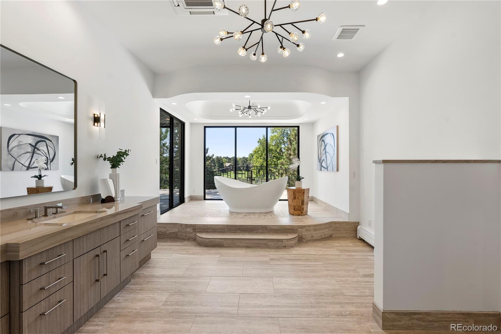 3962 South Chase Way Denver, CO 80235 - Photo 33 of 40 a large white room with a large window and chandelier