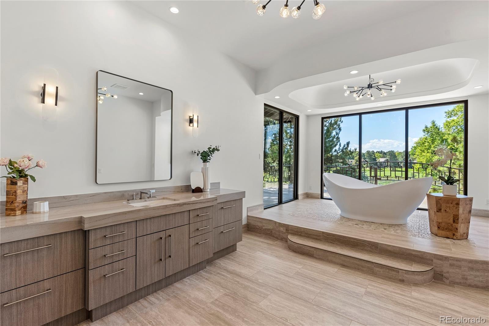 3962 South Chase Way Denver, CO 80235 - Photo 34 of 40 a spacious bathroom with a double vanity sink large mirror and window
