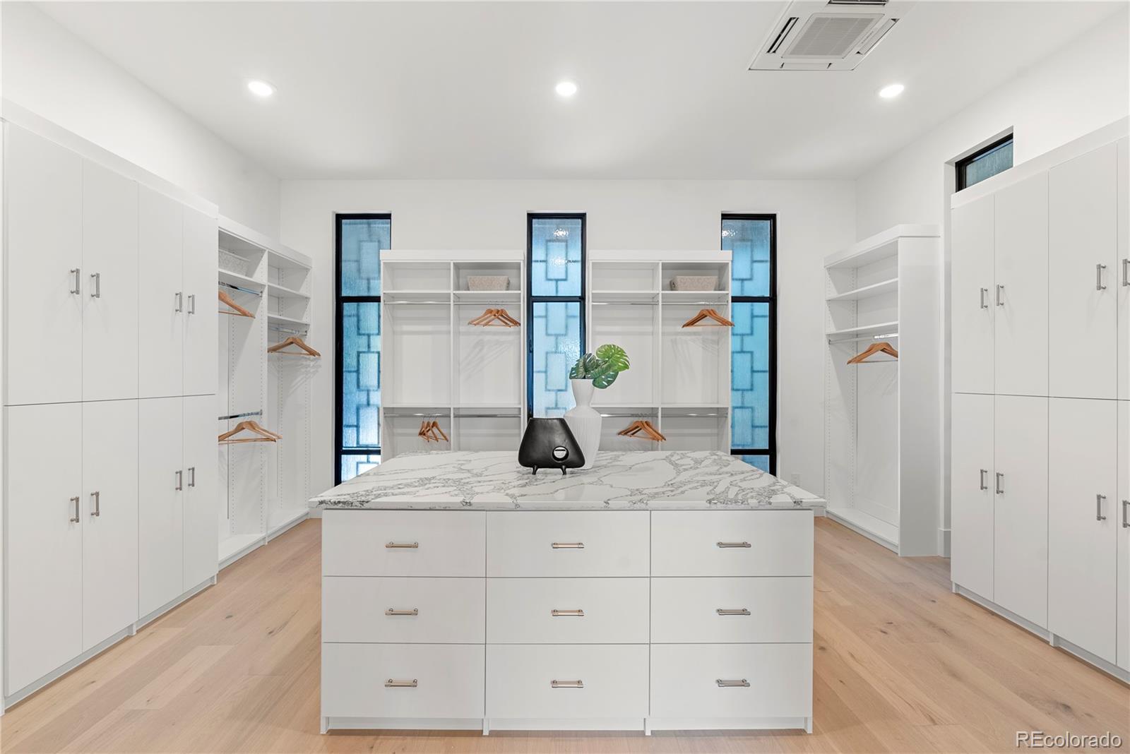 3962 South Chase Way Denver, CO 80235 - Photo 35 of 40 a bathroom with a granite countertop sink a mirror and shower