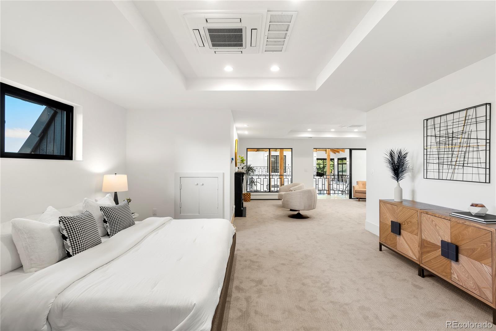 3962 South Chase Way Denver, CO 80235 - Photo 36 of 40 a large bedroom with bed and a large window