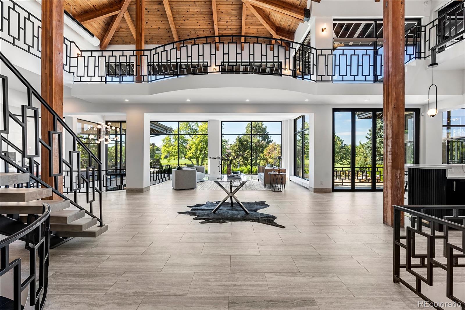 3962 South Chase Way Denver, CO 80235 - Photo 6 of 40 a building exterior with furniture and wooden floor