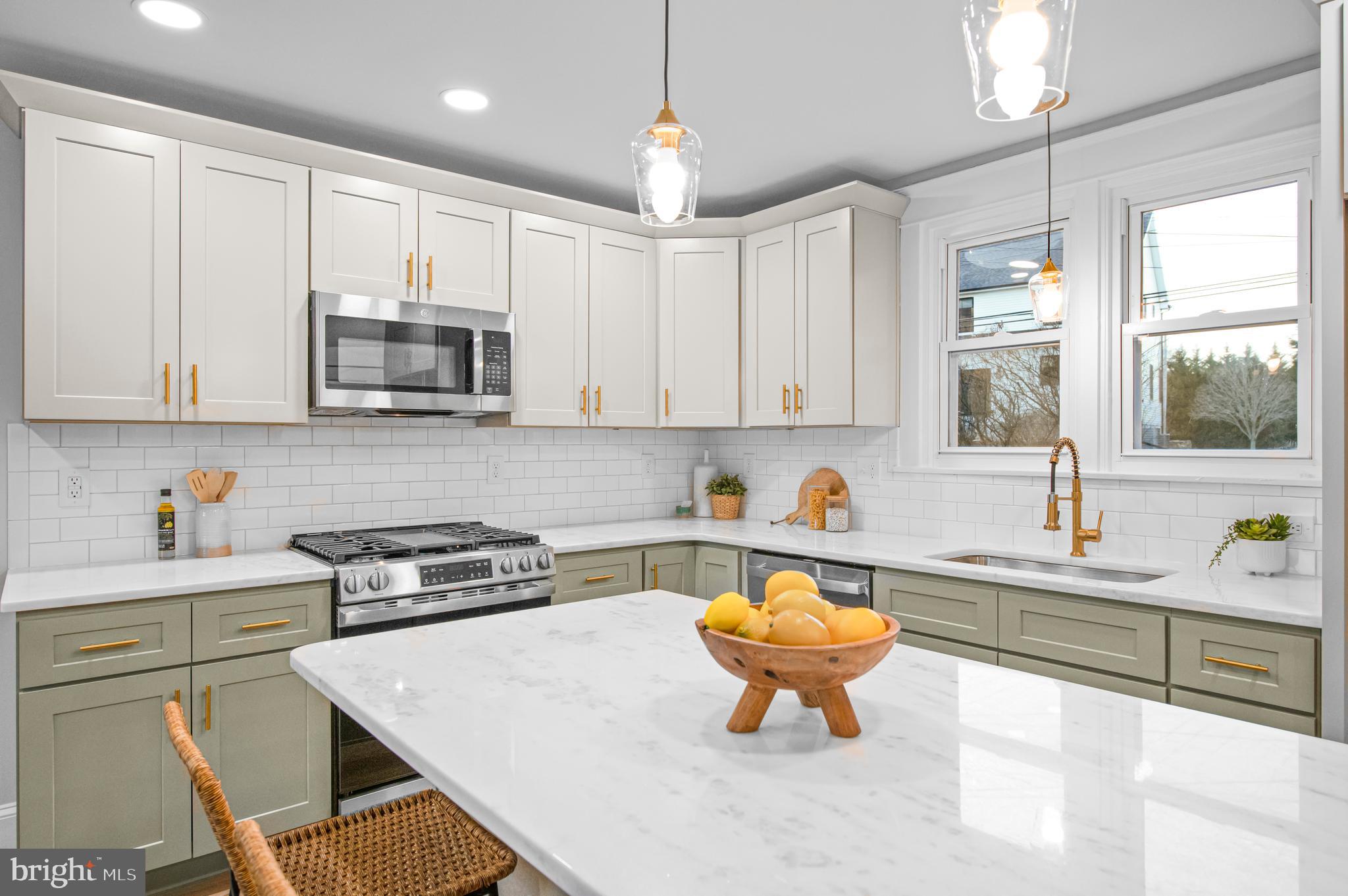 220 North Rolling Road Springfield, PA 19064 - Photo 2 of 41 a kitchen with stainless steel appliances a stove a sink a microwave a refrigerator and cabinets