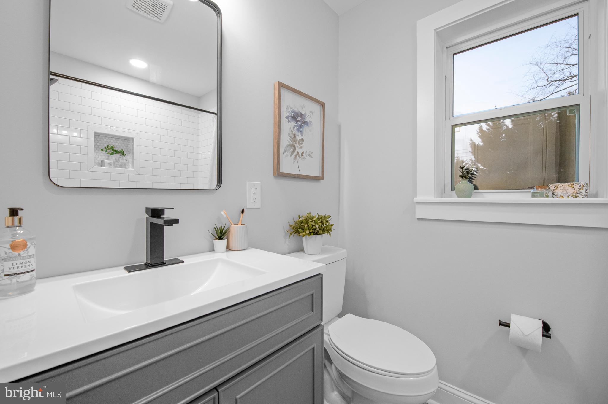 220 North Rolling Road Springfield, PA 19064 - Photo 21 of 41 a bathroom with a toilet a sink and a window