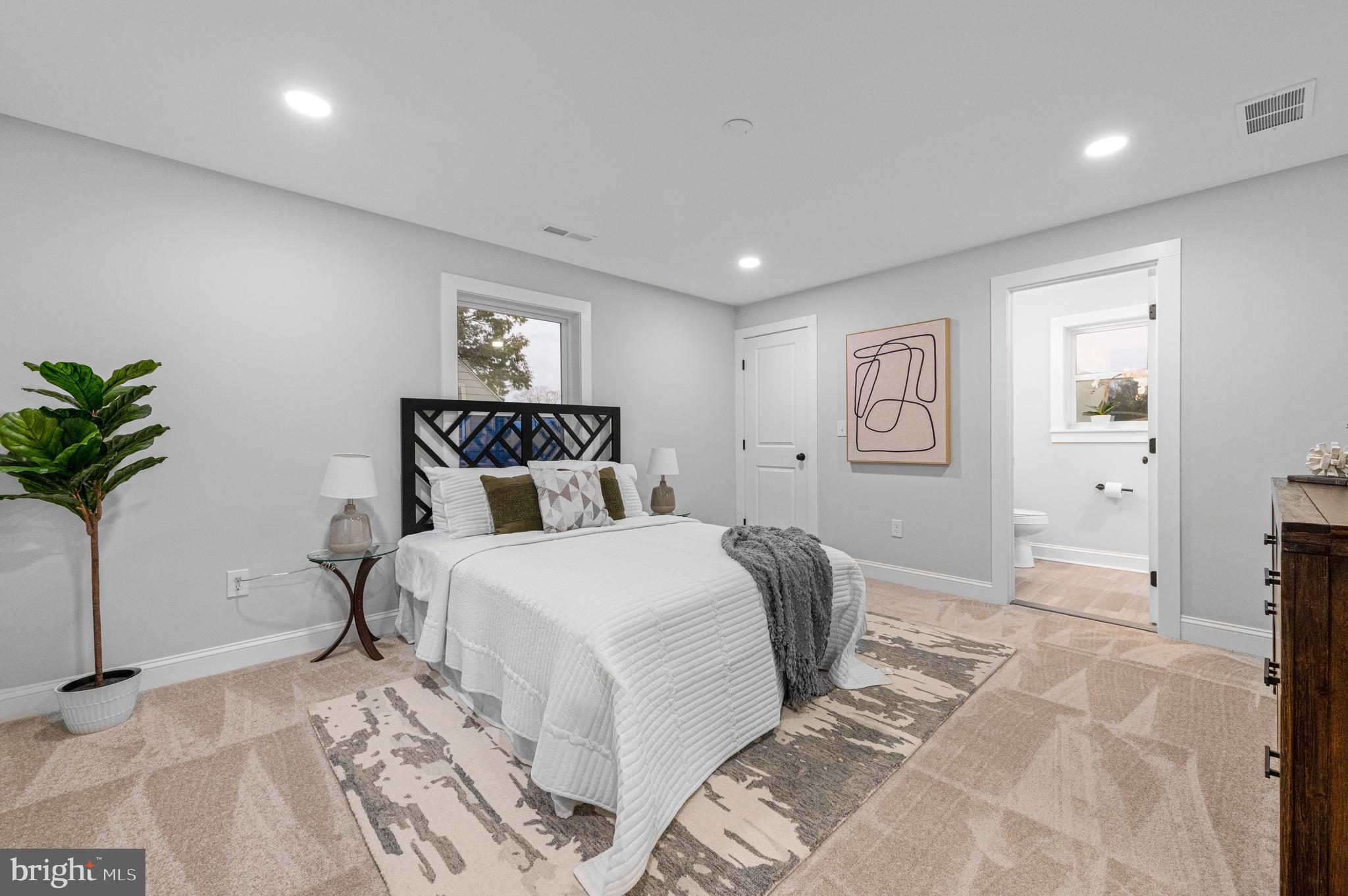 220 North Rolling Road Springfield, PA 19064 - Photo 25 of 41 a bedroom with a large bed and a potted plant