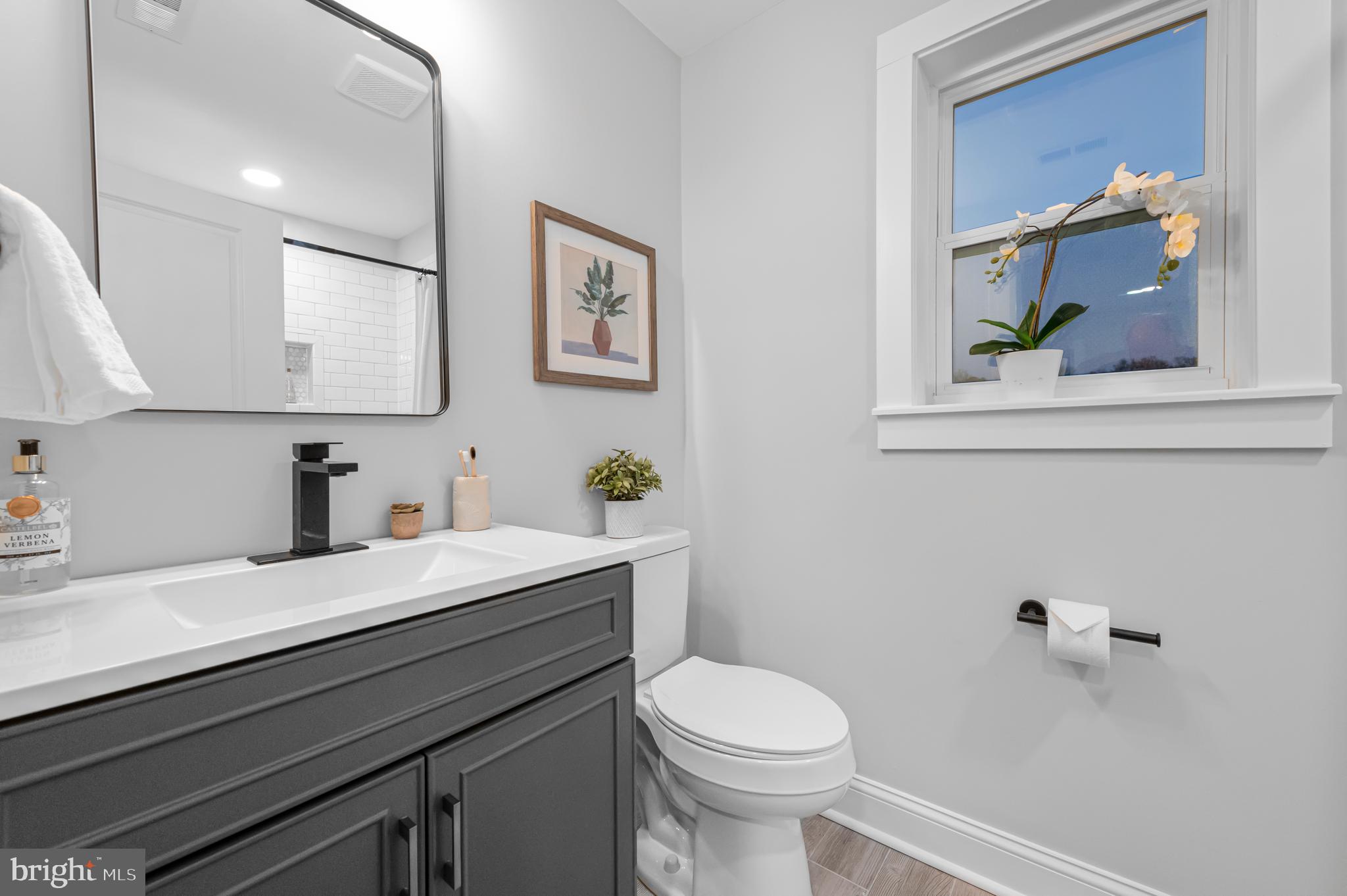 220 North Rolling Road Springfield, PA 19064 - Photo 27 of 41 a bathroom with a granite countertop sink a toilet and a mirror
