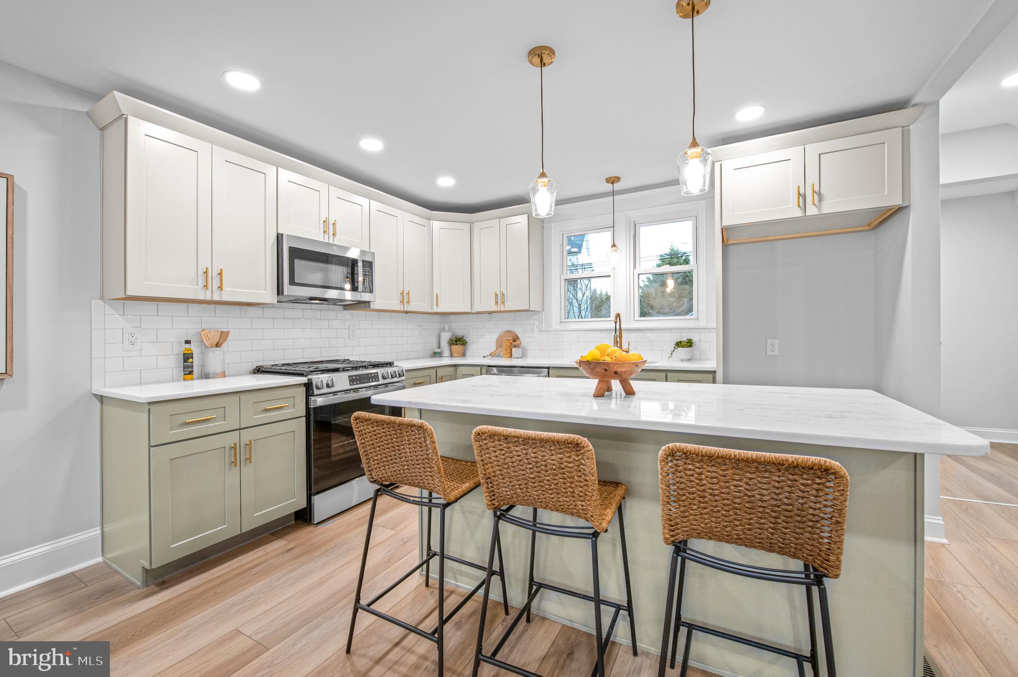220 North Rolling Road Springfield, PA 19064 - Photo 3 of 41 a kitchen with kitchen island granite countertop a sink a center island and appliances