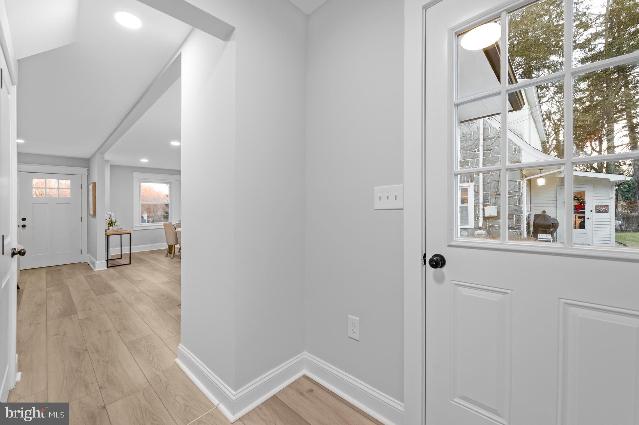 220 North Rolling Road Springfield, PA 19064 - Photo 36 of 41 a view of a hallway with wooden floor and a living room