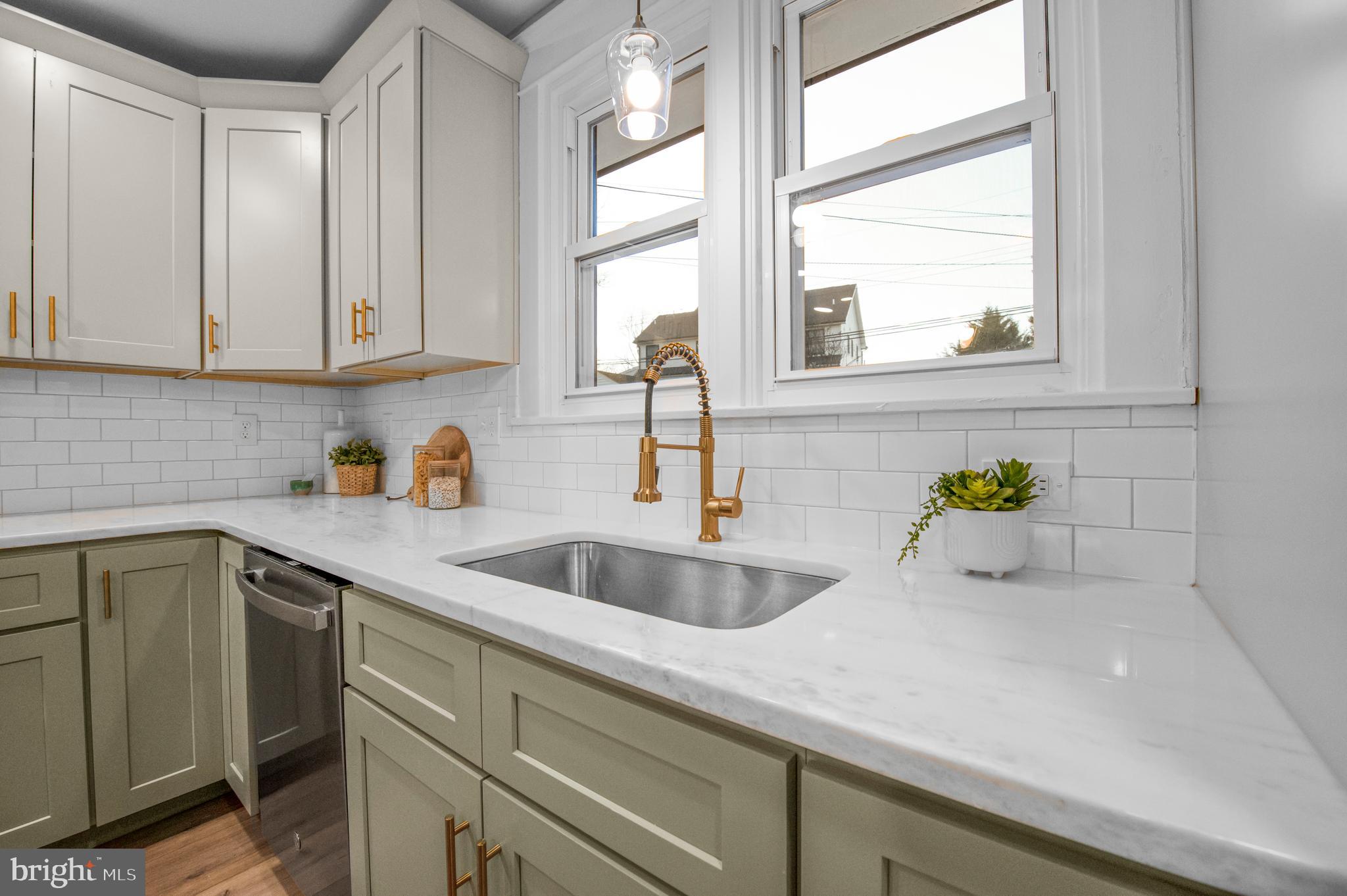 220 North Rolling Road Springfield, PA 19064 - Photo 5 of 41 a kitchen with stainless steel appliances white cabinets and a sink