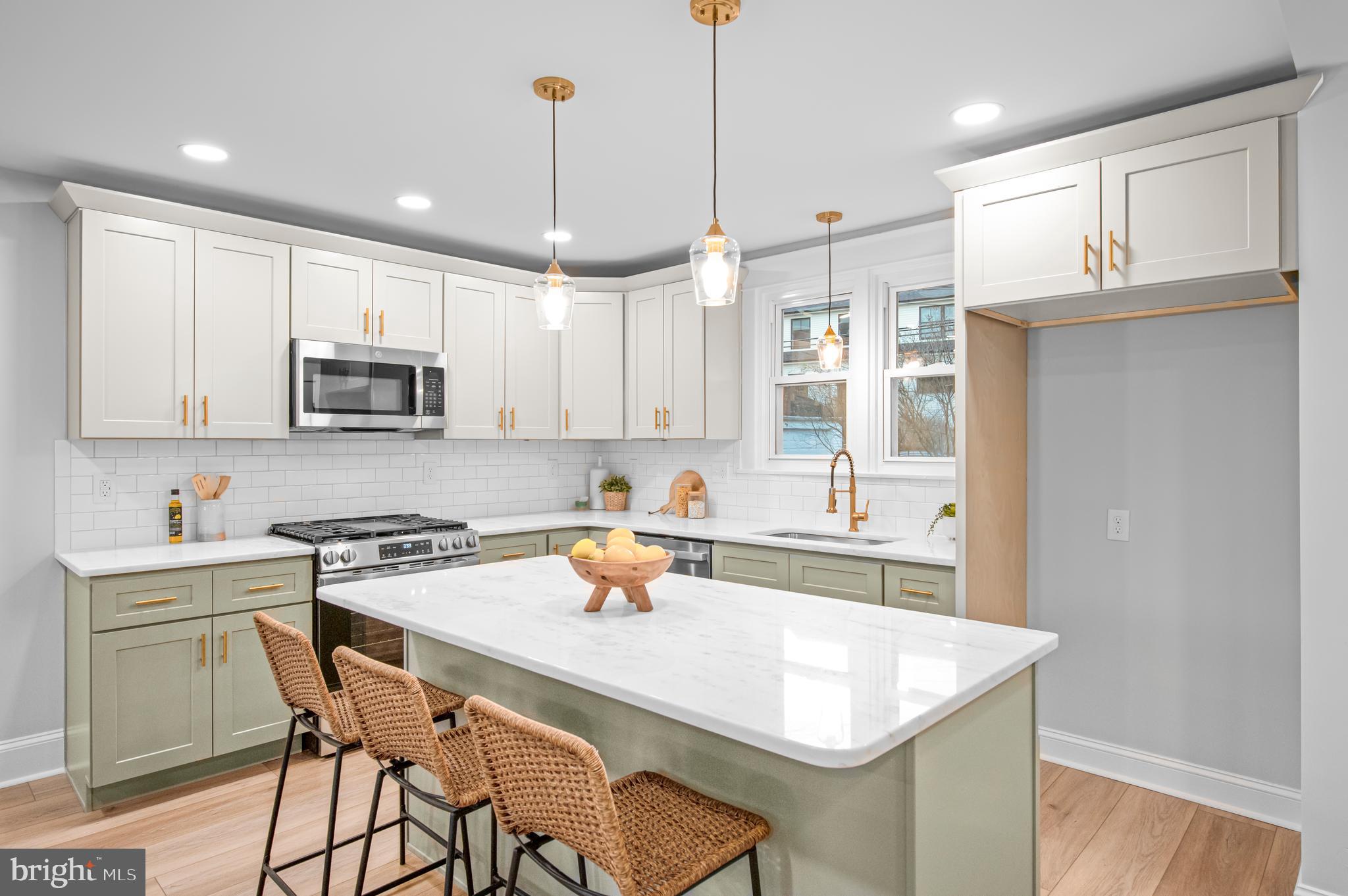 220 North Rolling Road Springfield, PA 19064 - Photo 6 of 41 a kitchen with a sink a stove a refrigerator and white cabinets with wooden floor
