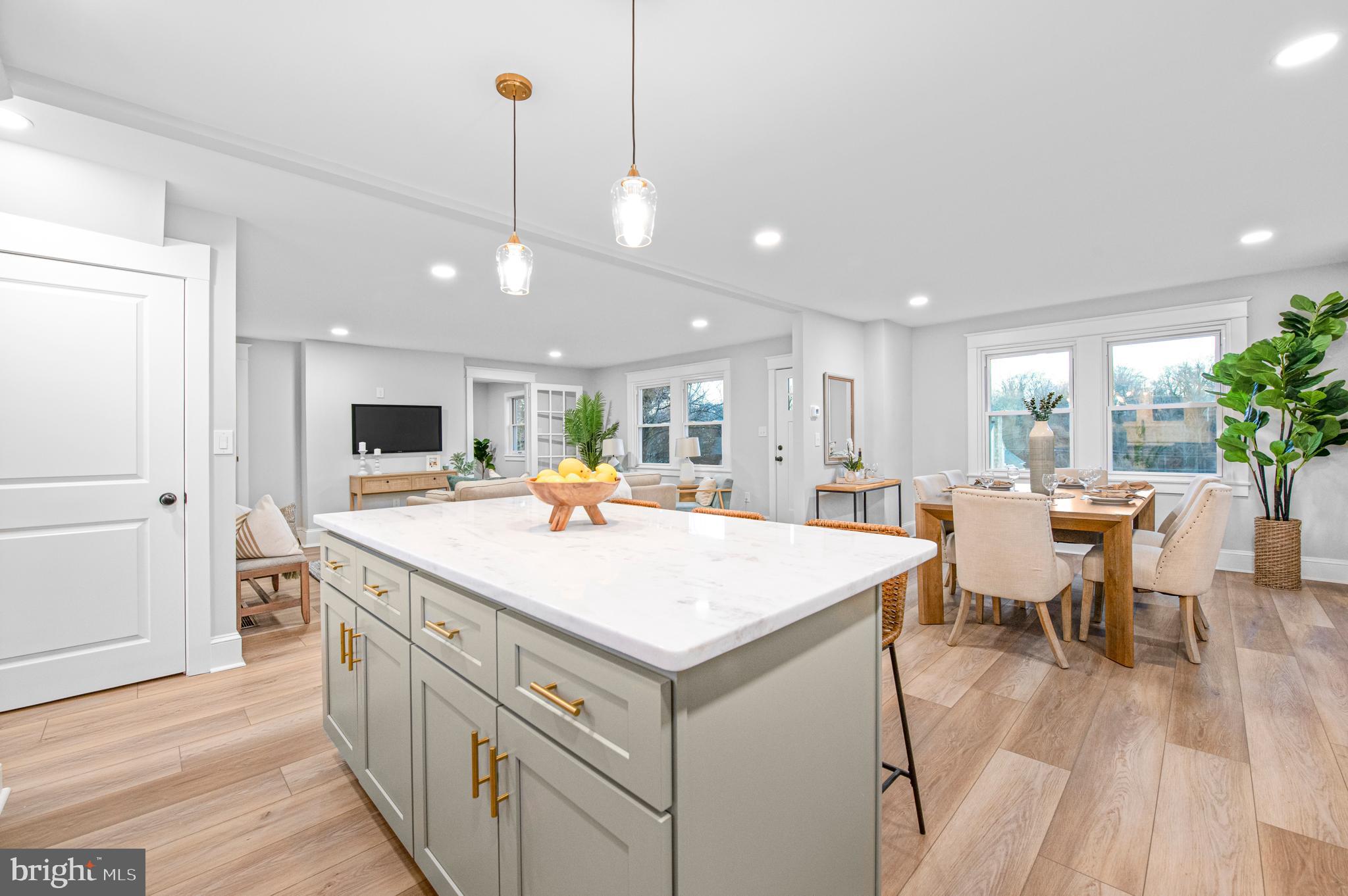 220 North Rolling Road Springfield, PA 19064 - Photo 9 of 41 a large kitchen with kitchen island a sink table and chairs