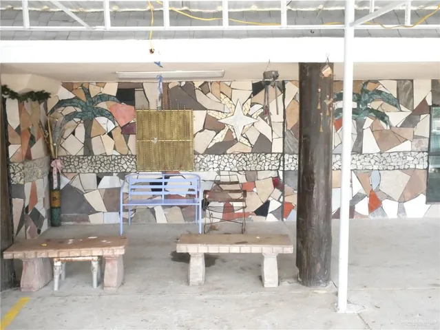 a view of a patio with a table and chairs