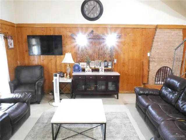 a living room with furniture a couch and a flat screen tv