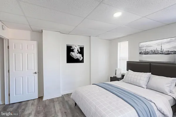 a bedroom with a bed and a painting on the wall