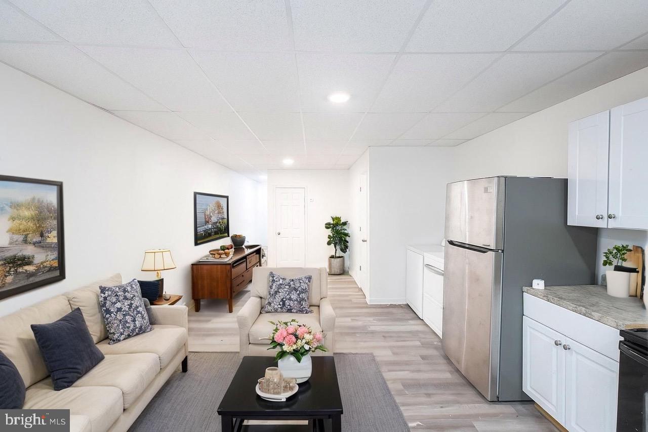 3207 Baker Street Baltimore, MD 21216 - Photo 2 of 14 a living room with furniture and a refrigerator