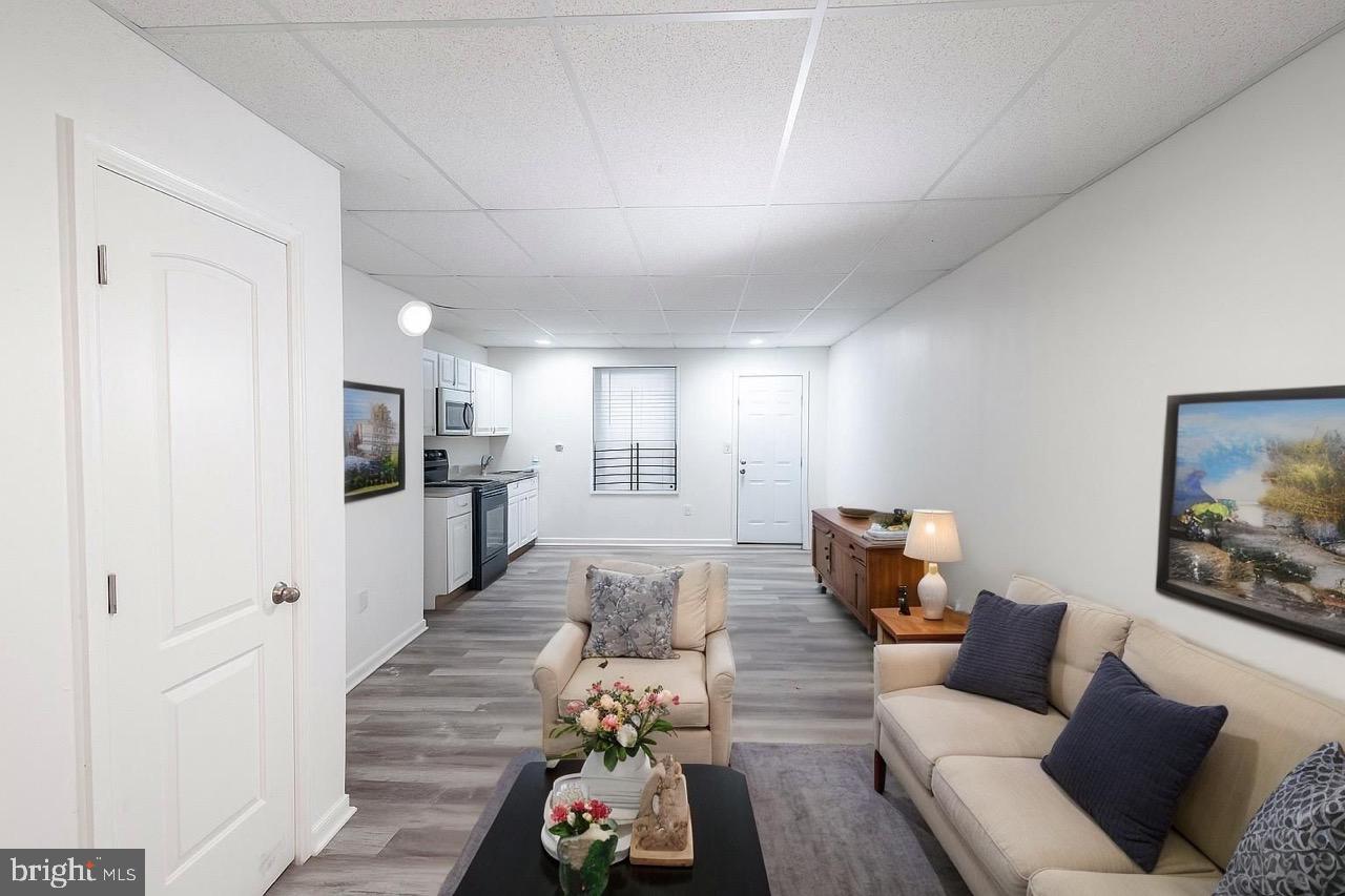 3207 Baker Street Baltimore, MD 21216 - Photo 3 of 14 a living room with furniture and wooden floor