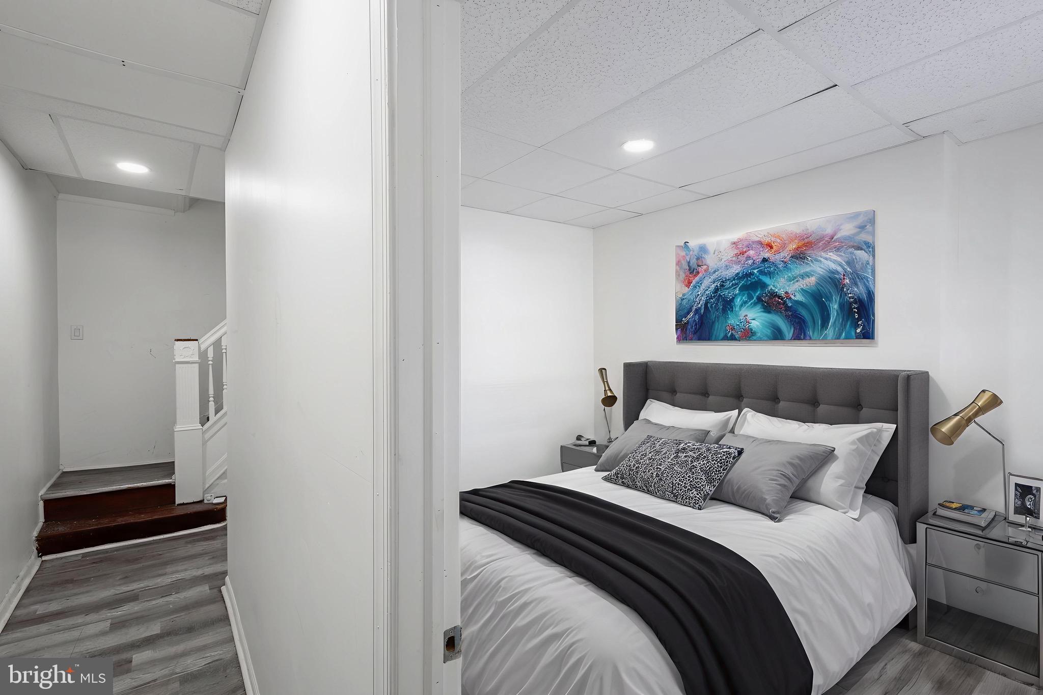 3207 Baker Street Baltimore, MD 21216 - Photo 5 of 14 a bedroom with a bed and a painting on the wall