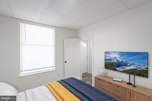 a bedroom with furniture and paintings on the wall
