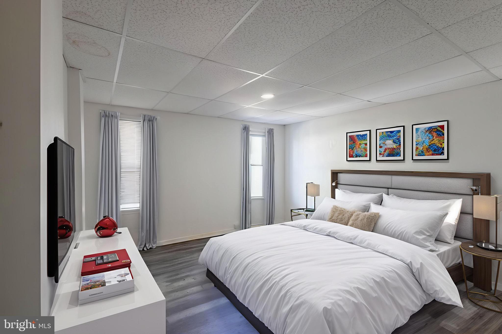 3207 Baker Street Baltimore, MD 21216 - Photo 10 of 14 a bedroom with a bed and wooden floor