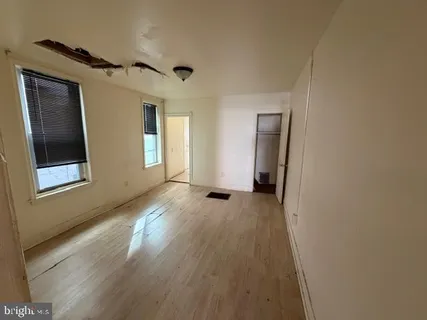 a view of a livingroom with wooden floor and window
