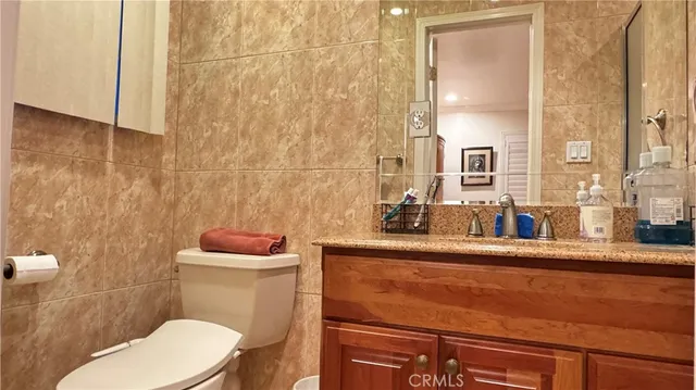 a bathroom with a sink a toilet and mirror