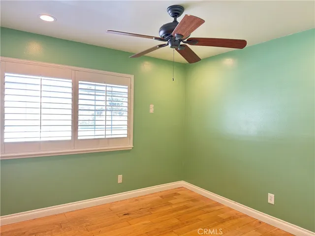 a view of a room with a fan and a window