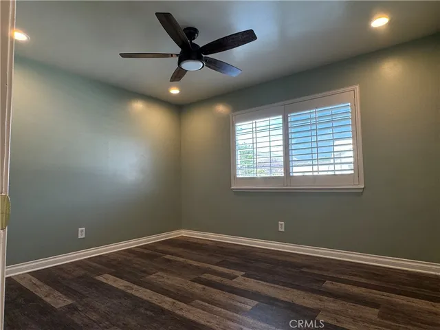 a view of a room with wooden floor and windows