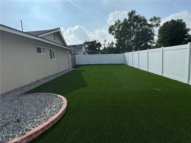 a view of a house with a yard and garage