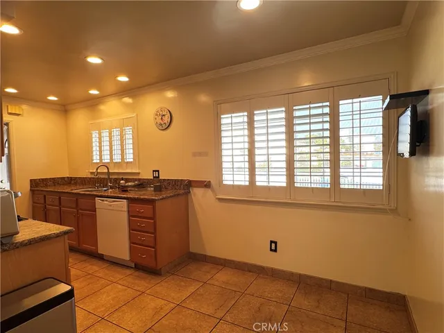 a kitchen with stainless steel appliances granite countertop a sink and a stove