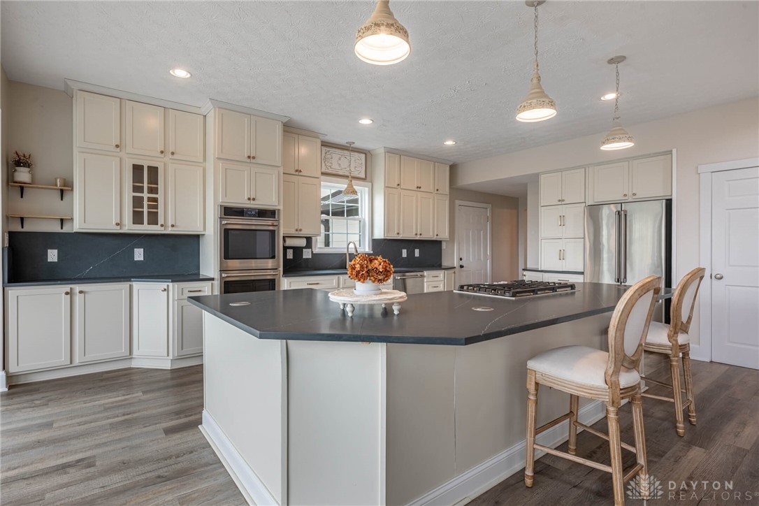 9586 Ferry Road Waynesville, OH 45068 - Photo 5 of 40 This spacious kitchen offers a blend of style and functionality, perfect for culinary endeavors.