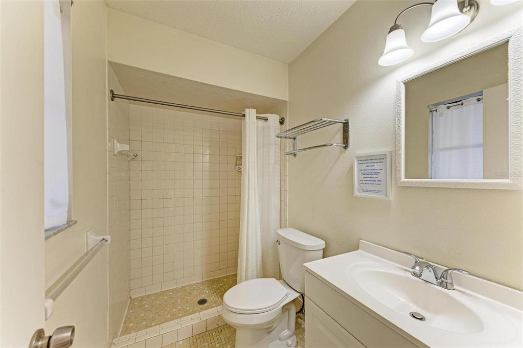 401 Shore Road Nokomis, FL 34275 - Photo 9 of 14 a bathroom with a sink toilet and shower