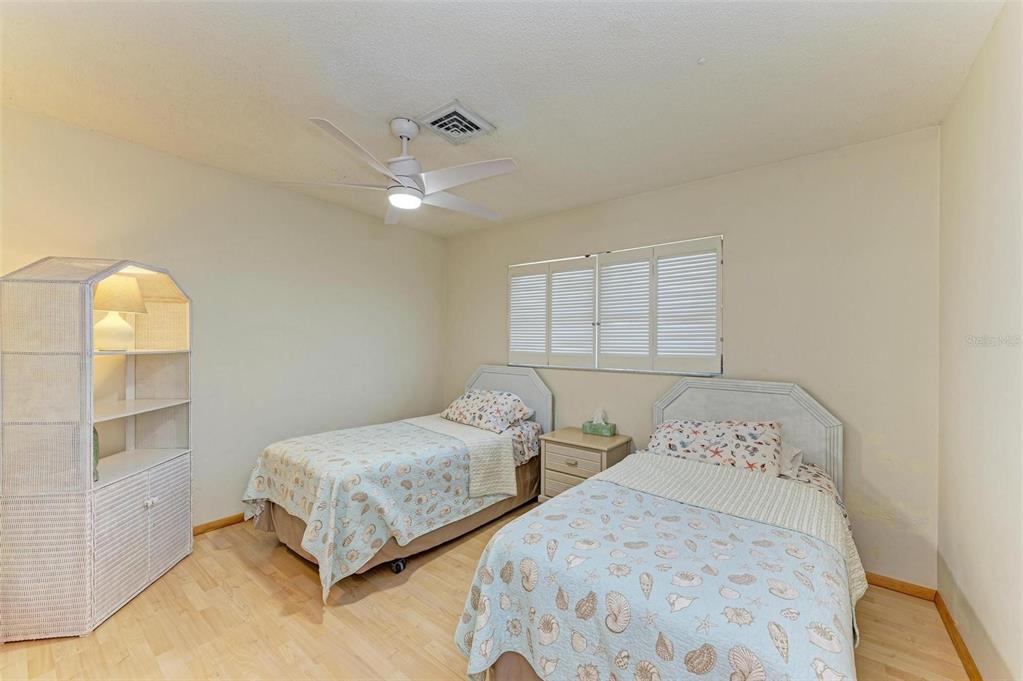 401 Shore Road Nokomis, FL 34275 - Photo 10 of 14 a bedroom with two beds and painted walls