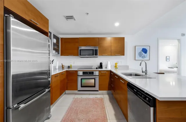 a kitchen with stainless steel appliances a refrigerator and a sink