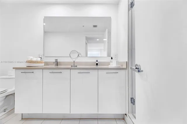 a large bedroom with a bed and a large mirror