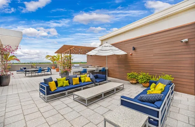 a swimming pool with outdoor seating and yard