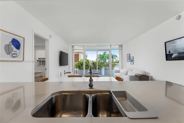 a view of kitchen with stainless steel appliances furniture refrigerator and dining table