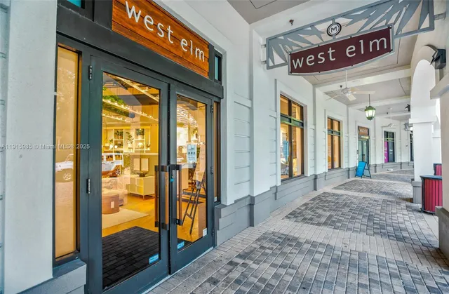a view of a chairs and table in front of a building