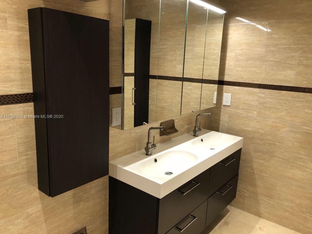 1220 West 62nd Street Hialeah, FL 33012 - Photo 16 of 53 a bathroom with a sink and a mirror