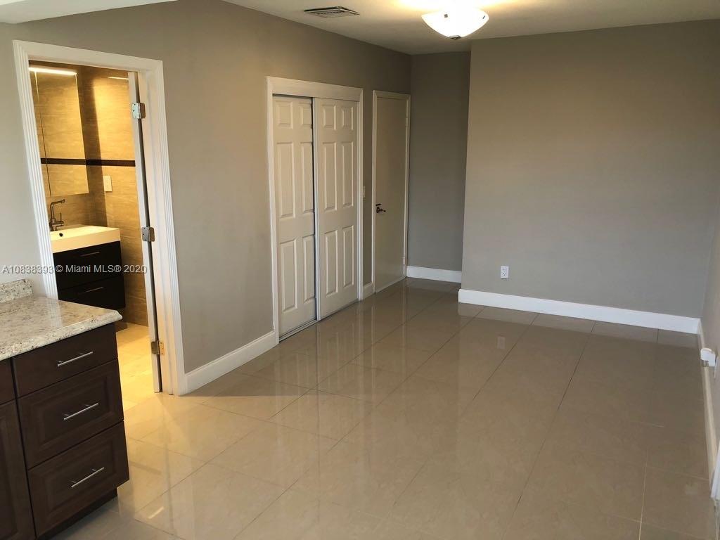 1220 West 62nd Street Hialeah, FL 33012 - Photo 18 of 53 an empty room with windows
