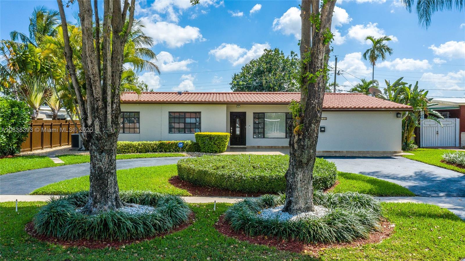 1220 West 62nd Street Hialeah, FL 33012 - Photo 2 of 53 a front view of a house with garden